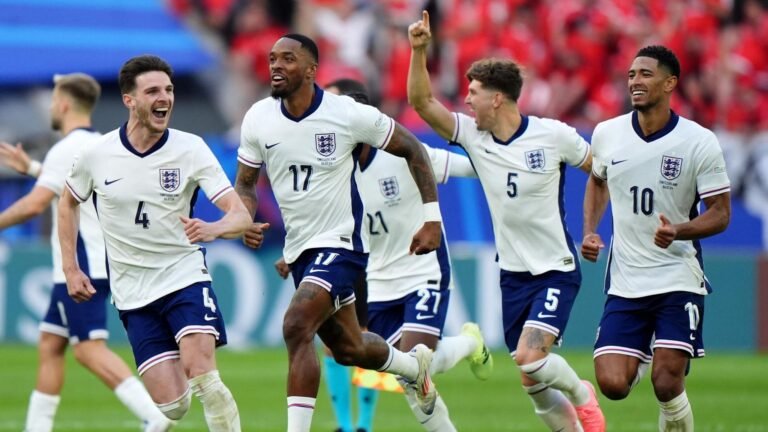 Declan Rice, Ivan Toney, Jude Bellingham, and the squad race together to celebrate.